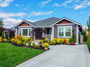 Photo of a modern custom single-level suburban home on a sunny summer day