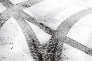 tire tracks on snowy asphalt