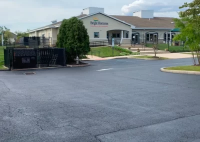 The Bright Horizons building and parking lot under a cloudy sky.