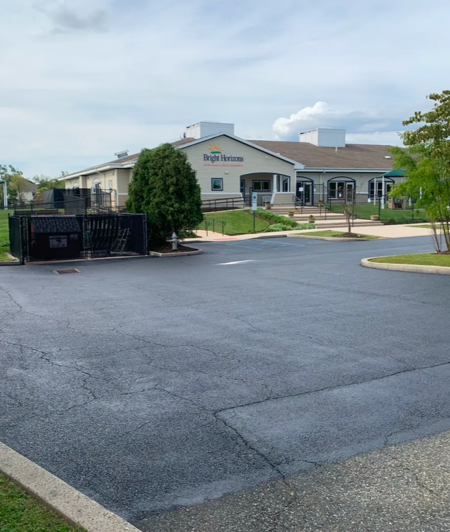 A daycare building with a sign reading "Bright Horizons" and an empty parking lot in front.